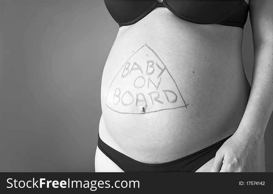 Expectant mother with writing baby on board