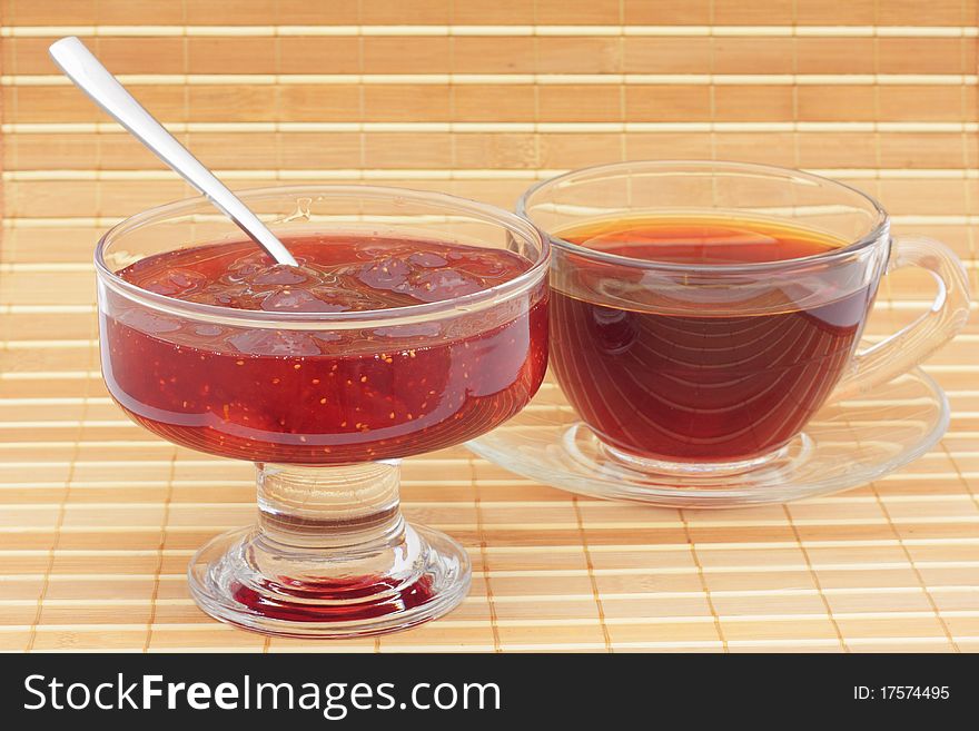 Jam and tea in glass cup. Jam and tea in glass cup