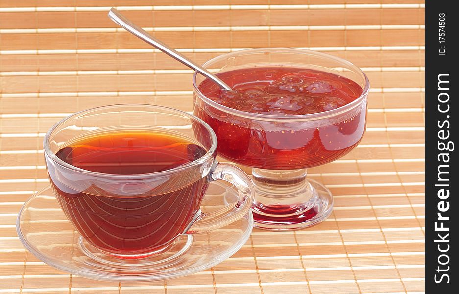 Jam and tea in glass cup. Jam and tea in glass cup