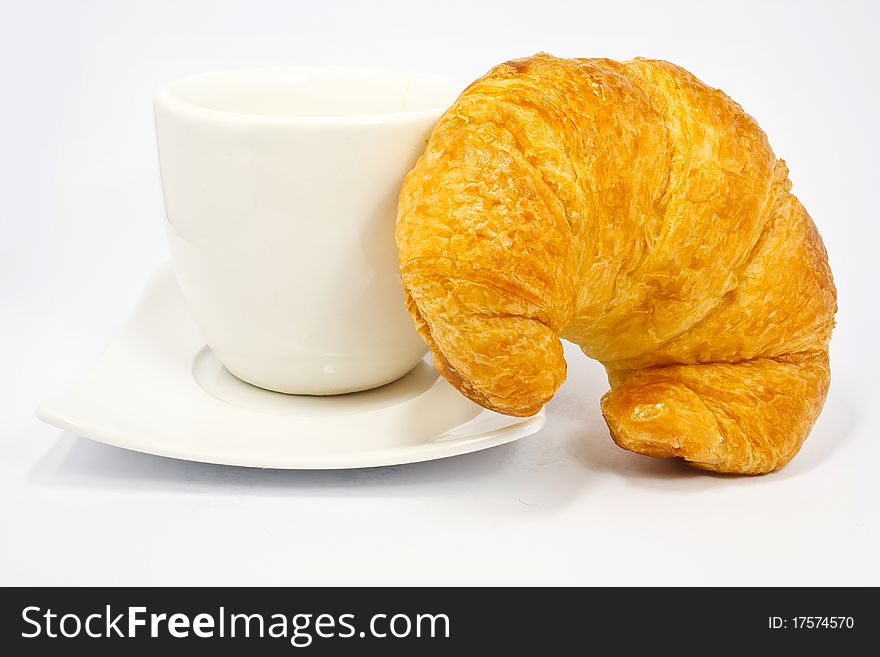 Single fresh croissant, casting soft whadow on white. Delicious!