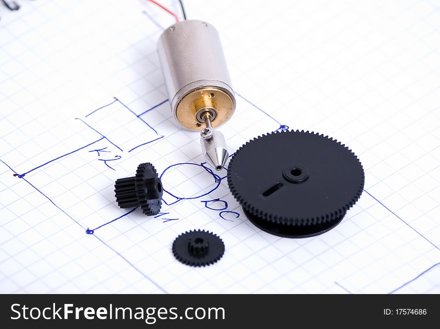 Electrical motor and gears over schematic. Electrical motor and gears over schematic