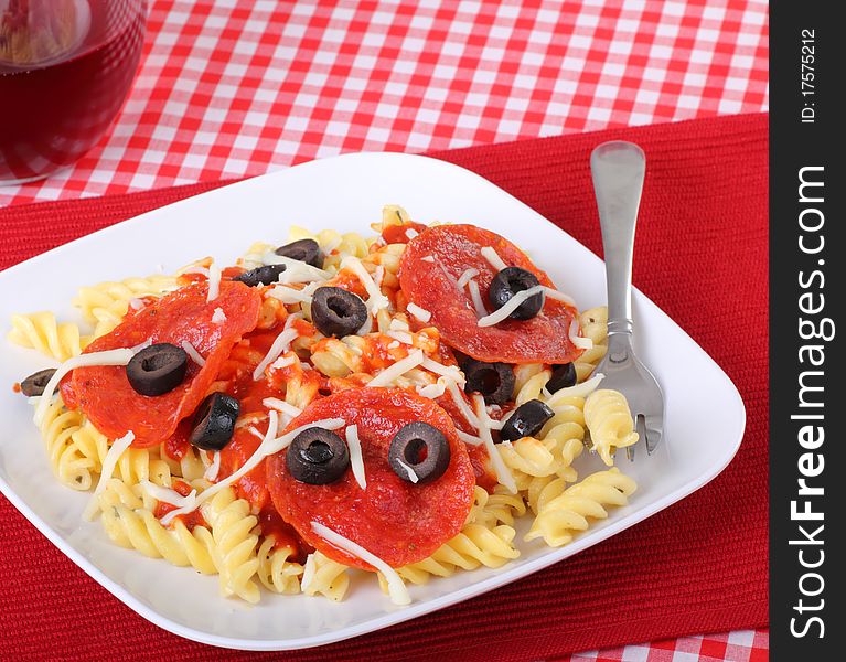 Rotini pasta noodles with peperoni and black olives. Rotini pasta noodles with peperoni and black olives