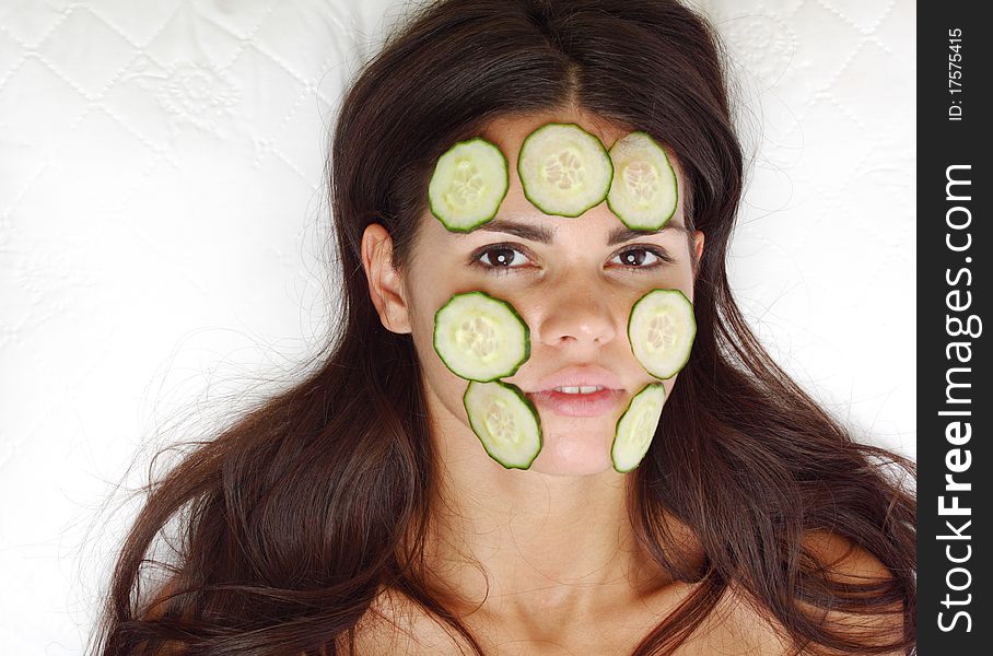 Cucumbers circles on a girl face. Cucumbers circles on a girl face