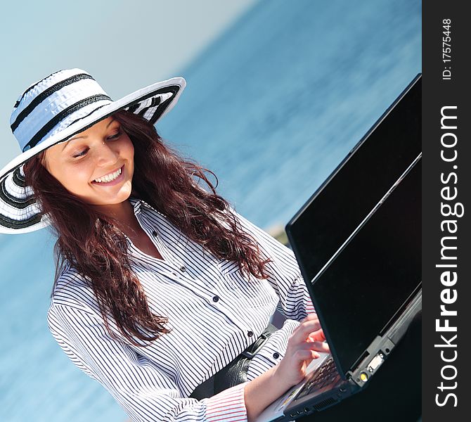 Woman with laptop sea background. Woman with laptop sea background