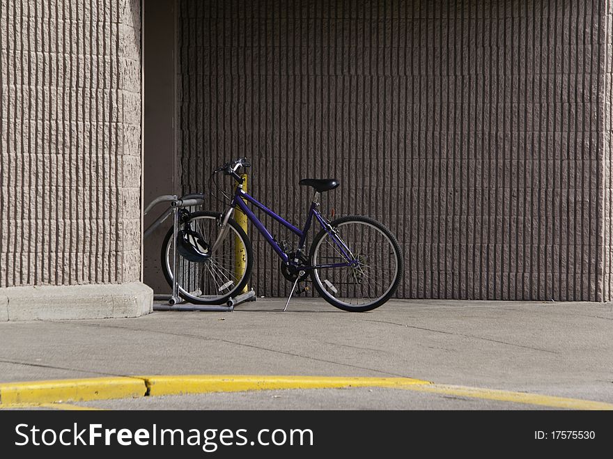 A bicycle left by its owner while they shopped or worked. A bicycle left by its owner while they shopped or worked.