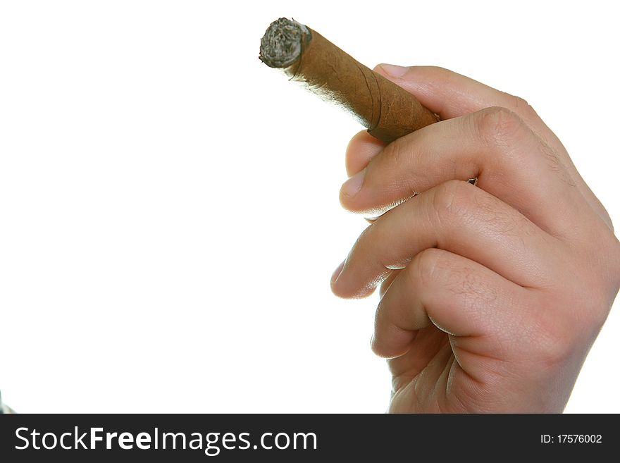 The man's hand holds fingers a cigaret on a white background. The man's hand holds fingers a cigaret on a white background