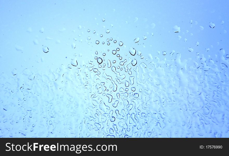 An image of raindrops at the window