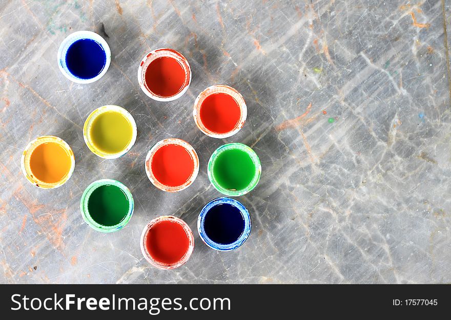 Opened buckets with paint different colors with paintbrush. Opened buckets with paint different colors with paintbrush