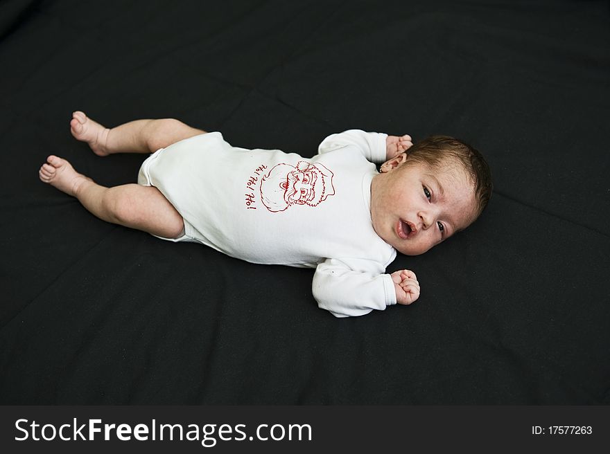 Wake-up little baby girl holding out her arms and fits