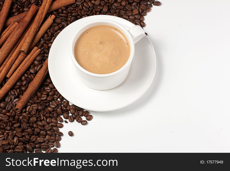 White coffee mug coffee beans and cinnamon sticks