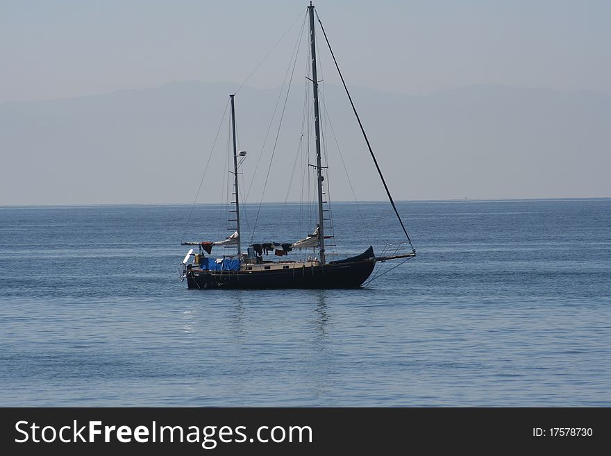 A sailboat rests at anchor on the calm waters of Banderas Bay near Puerto Vallarta, Mexico. A sailboat rests at anchor on the calm waters of Banderas Bay near Puerto Vallarta, Mexico.