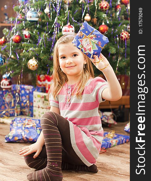 Little girl under christmas tree. Little girl under christmas tree