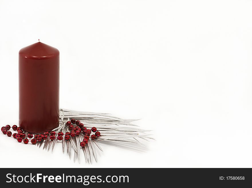 Red candle and silver leaves as a christmas decoration