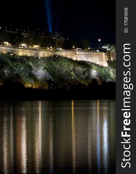 Petrovaradin Fortress at night with reflection in Danube river during EXIT Music festival