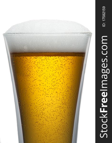 Beer into glass isolated on white