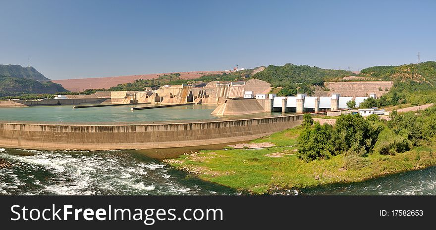 Panorama photo of water electricity plant on yellow river in China, as big construction made by concrete built beside yellow river. Panorama photo of water electricity plant on yellow river in China, as big construction made by concrete built beside yellow river.