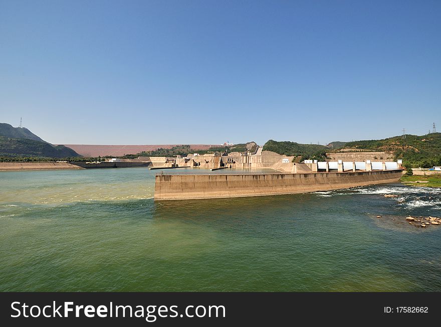 Wide angle of water electricity plant on yellow river in China, as big construction made by concrete built beside yellow river. Wide angle of water electricity plant on yellow river in China, as big construction made by concrete built beside yellow river.