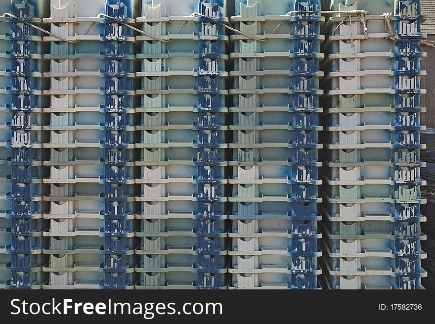 These were a stack of containers on a dock waiting to be filled with fish. These were a stack of containers on a dock waiting to be filled with fish.