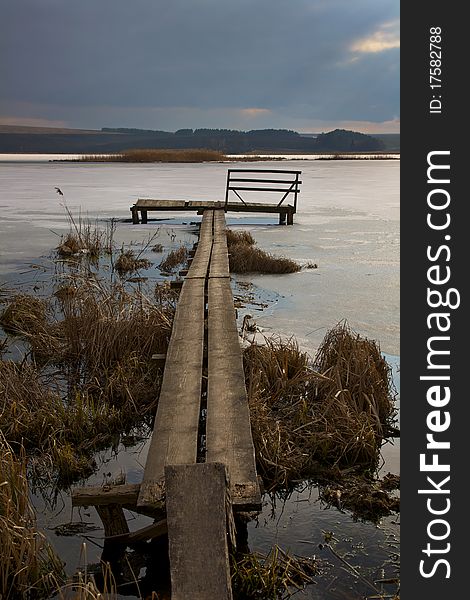 The bridge on the beautiful frozen lake. The bridge on the beautiful frozen lake.