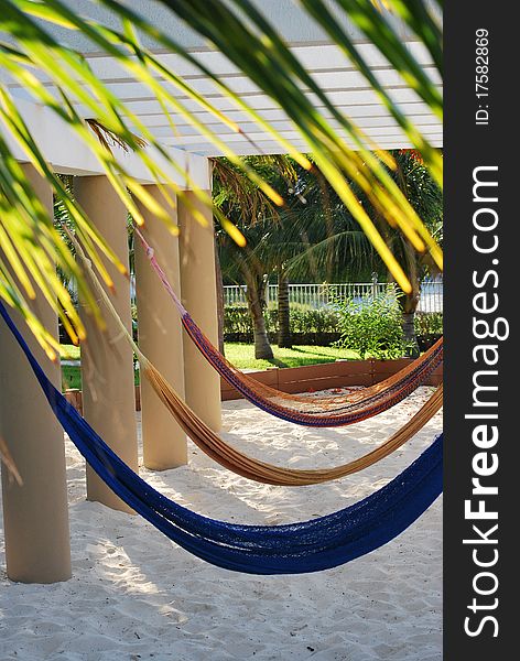 Hammocks by the palm trees inviting to take a break. Hammocks by the palm trees inviting to take a break