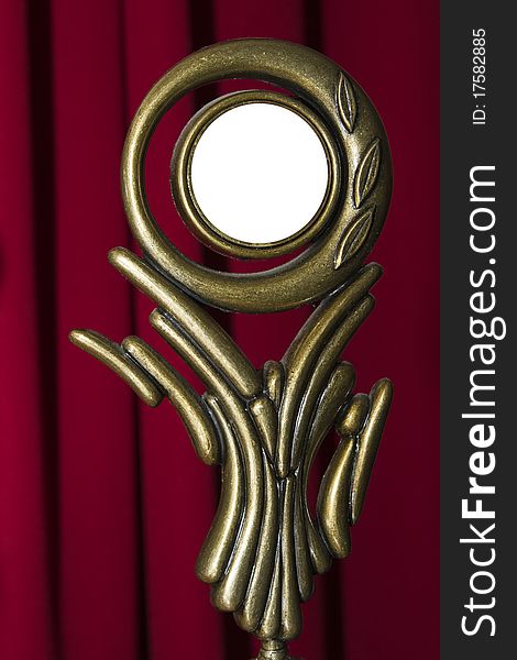 Brass reward statuette with copy space isolated on red curtain