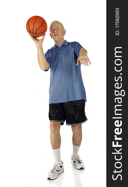 A senior man aiming his basketball for a one-handed shot. Isolated on white. A senior man aiming his basketball for a one-handed shot. Isolated on white.