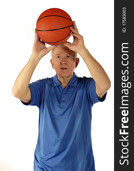 A senior man preparing a two-handed basketball shoot. Isolated on white. A senior man preparing a two-handed basketball shoot. Isolated on white.