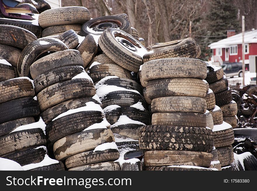 Old tires in a salvage yard in winter