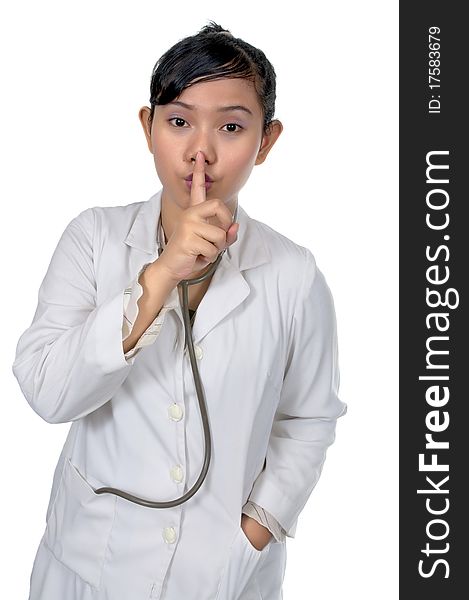 Beautiful young doctor say silent and wearing white coat isolated over white background. Beautiful young doctor say silent and wearing white coat isolated over white background