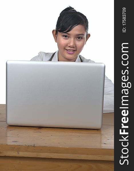 Beautiful young doctor working in front of laptop isolated over white background. Beautiful young doctor working in front of laptop isolated over white background