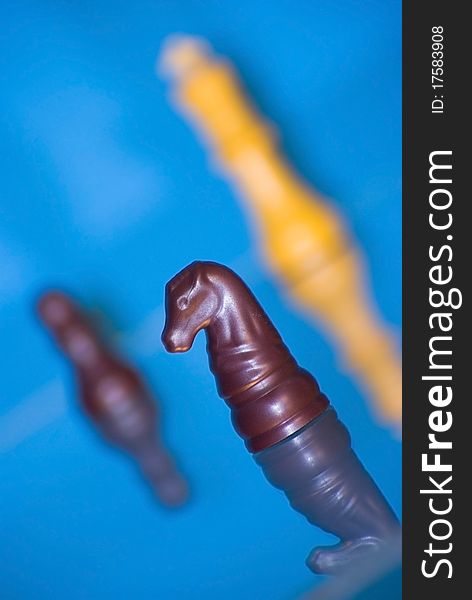 Three chess pieces against a blue background
