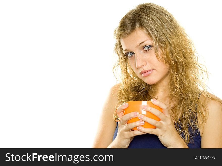 Pretty young woman with an orange cup of tea / coffee. Isolated on white background. Pretty young woman with an orange cup of tea / coffee. Isolated on white background