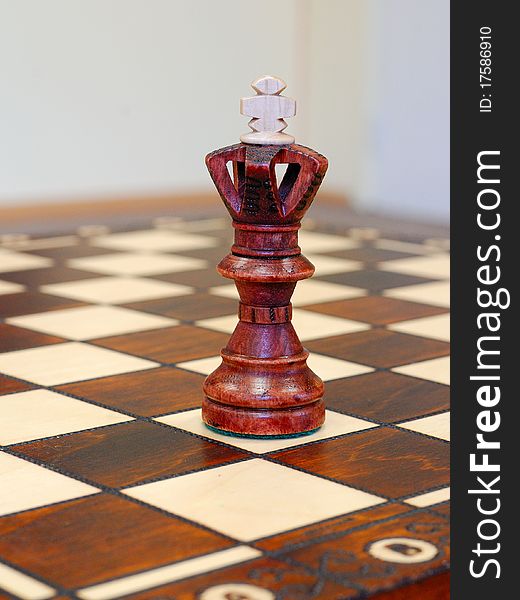 Wooden chess figures on game board