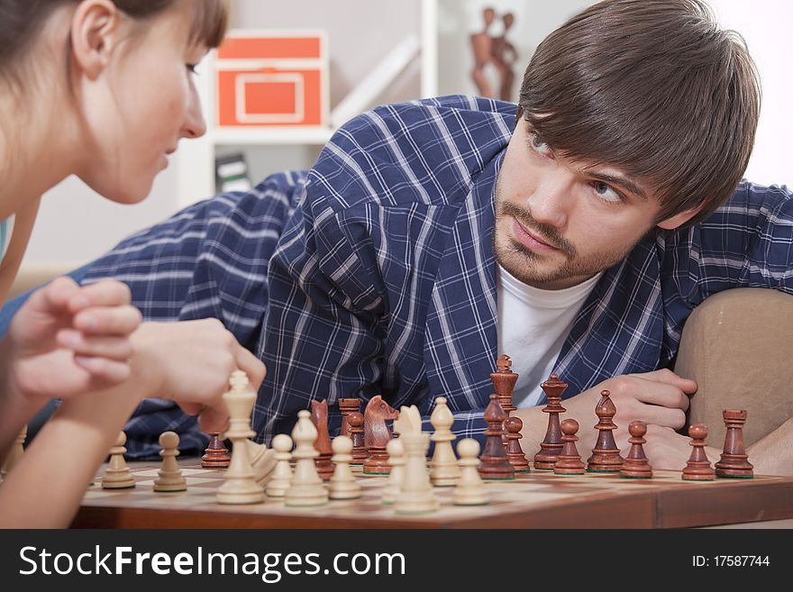 Man and woman playing chess at home. Man and woman playing chess at home