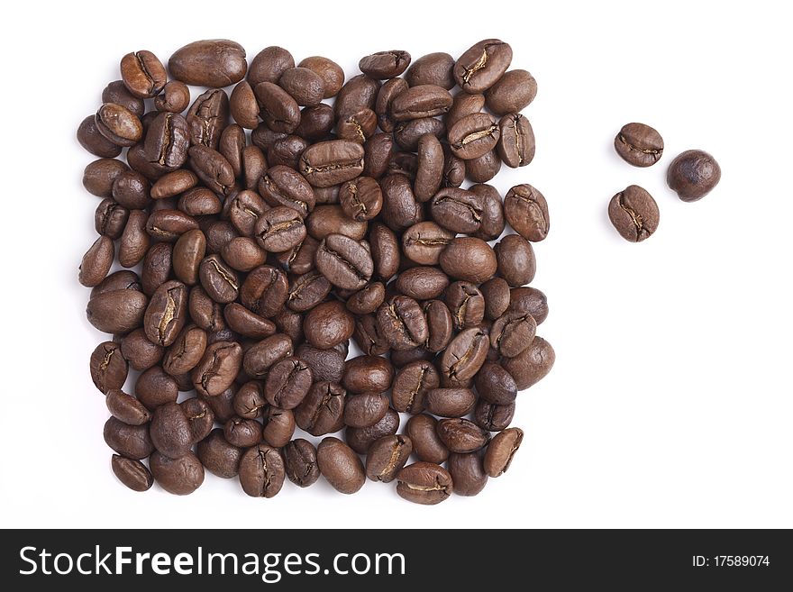 Roasted coffee beans are a handful on a white background and three grains are separated. Roasted coffee beans are a handful on a white background and three grains are separated
