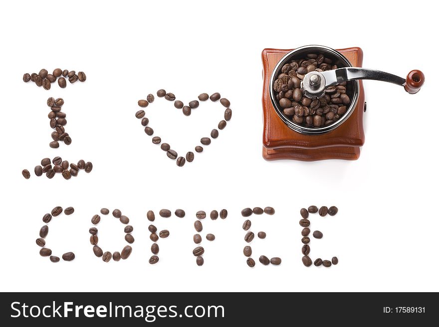 Grinder is made of brown wood with grains of coffee and an inscription from the coffee beans on white background. Grinder is made of brown wood with grains of coffee and an inscription from the coffee beans on white background