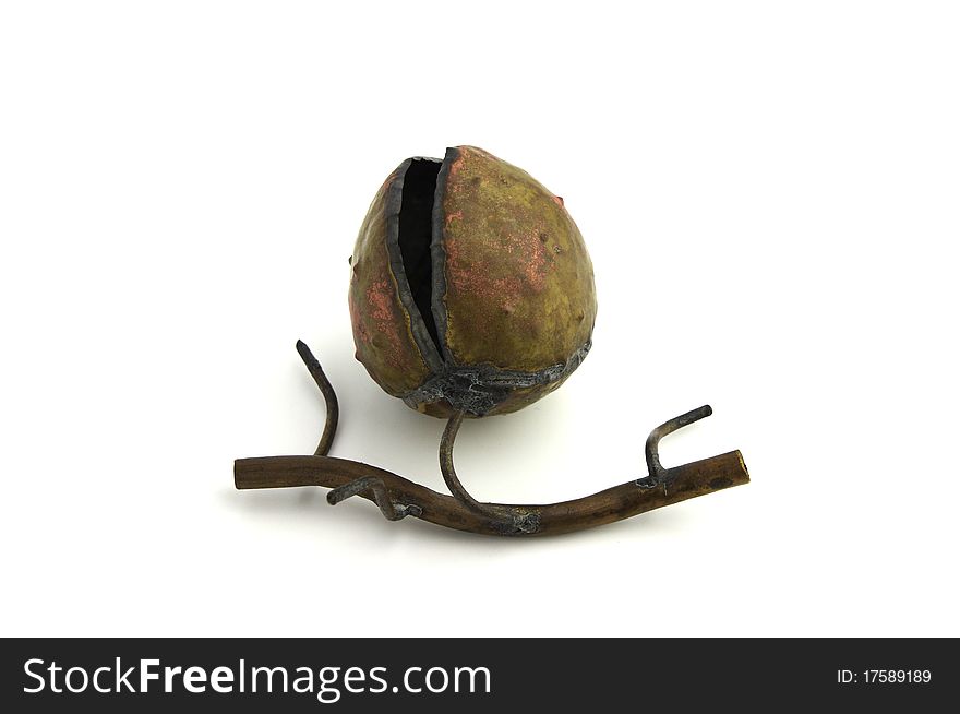 A metal forged open chestnut decoration with short branch on white background. A metal forged open chestnut decoration with short branch on white background