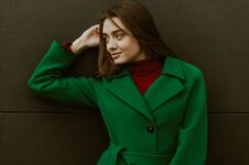 Beautiful Fashion Model In Autumn Green Clothes On Background. Sexy Lady In Elegant Coat Royalty Free Stock Photo