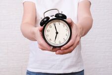 Woman Holding An Alarm Clock In Hands, The Time Is 7 Am, Early Morning Waking Up Stock Images