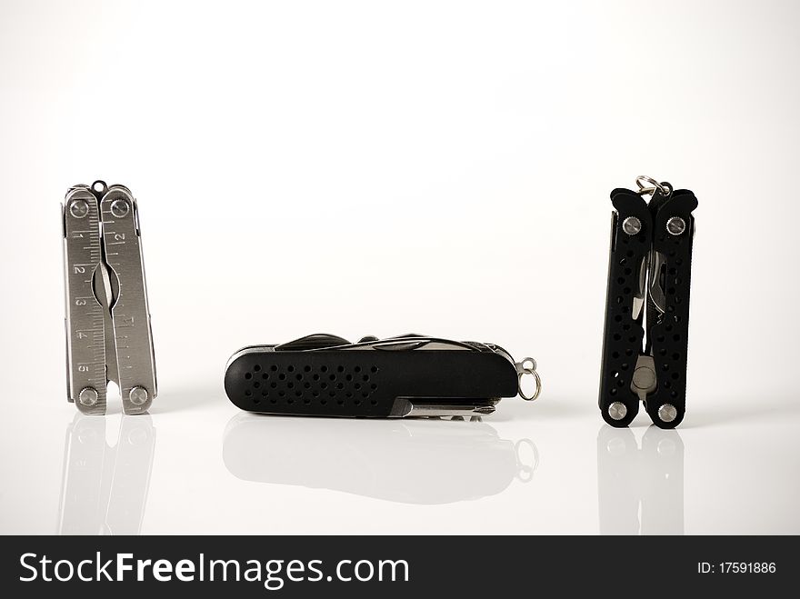 A horizontal image of three different multitools. A horizontal image of three different multitools