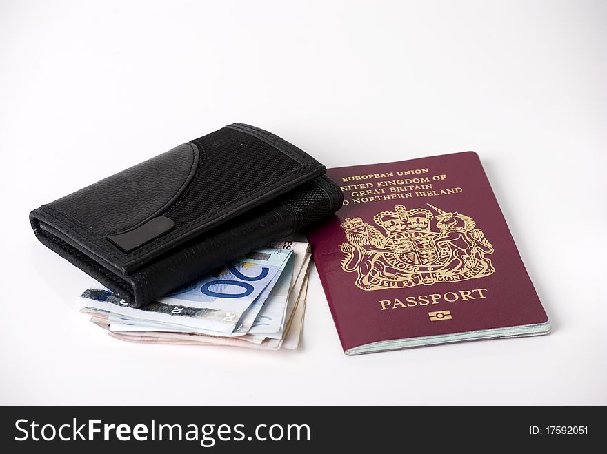 A horizontal image of bank notes sticking out of a black leather mans wallet with a passport. A horizontal image of bank notes sticking out of a black leather mans wallet with a passport