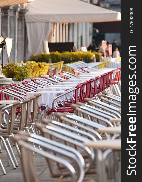 Outdoor cafet with red chair and white tablecloths. Outdoor cafet with red chair and white tablecloths