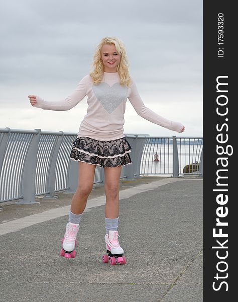 Image showing pretty young female on roller skates smiling