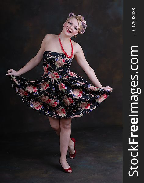 Photograph showing retro style 50s female posing against black. Photograph showing retro style 50s female posing against black