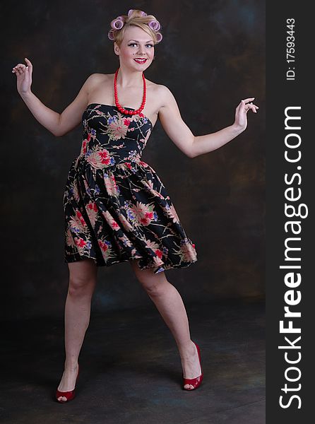Photograph showing retro style 50s female posing against black. Photograph showing retro style 50s female posing against black