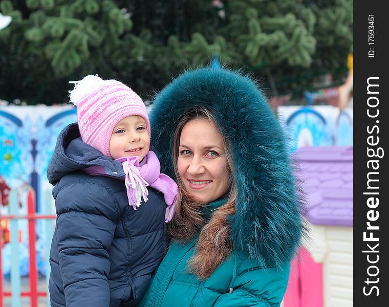 Mom and girl near a Christmas tree