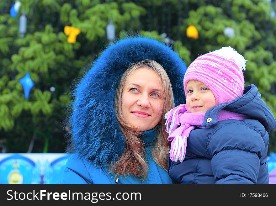 Mom And Girl Near A Christmas Tree