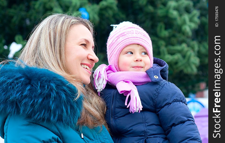 Happi Mom and girl near a Christmas tree