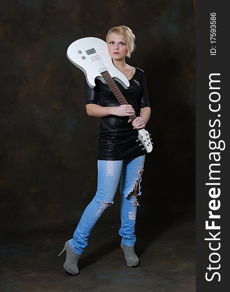Images showing pretty young female with white electric guitar. Images showing pretty young female with white electric guitar