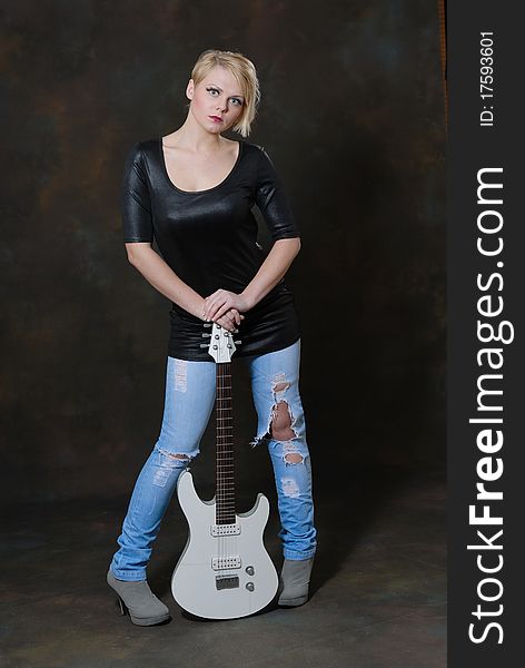 Images showing pretty young female with white electric guitar. Images showing pretty young female with white electric guitar